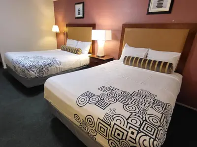 a hotel room with two beds and two lamps at Star Inn On Route 66, Barstow in Barstow