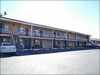 a building with a car parked in a parking lot at Star Inn On Route 66, Barstow in Barstow
