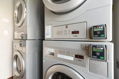 a laundry room with a washer and dryer at Chase Suites Brea-Fullerton - North Orange County in Brea