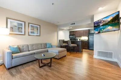 a living room with a couch and a table at Chase Suites Brea-Fullerton - North Orange County in Brea