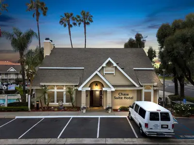 a white van parked in front of a house at Chase Suites Brea-Fullerton - North Orange County in Brea