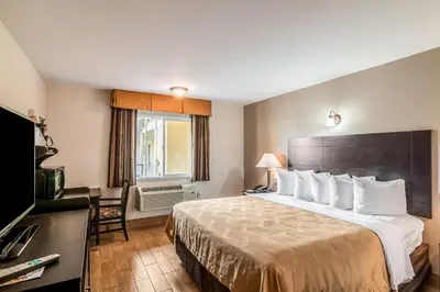a hotel room with a large bed and a window at Quality Inn & Suites near Downtown Bakersfield in Bakersfield