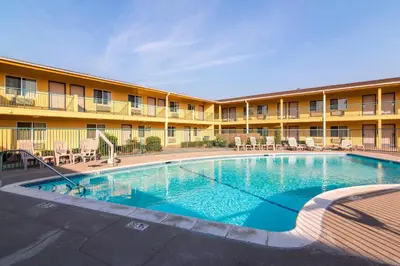 a large swimming pool in front of a hotel at Quality Inn & Suites near Downtown Bakersfield in Bakersfield