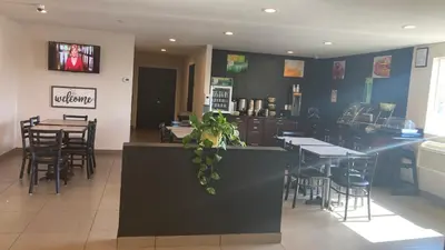 a dining room with tables and chairs in a restaurant at Quality Inn & Suites near Downtown Bakersfield in Bakersfield