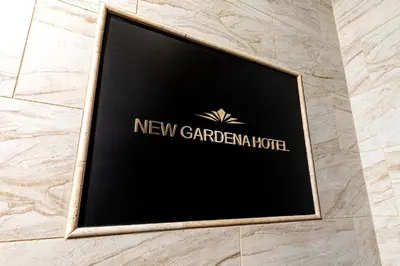 a sign for a new gardenia hotel on a wall at New Gardena Hotel in Gardena