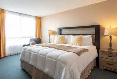 a hotel room with a large bed and a window at New Gardena Hotel in Gardena