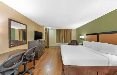 a hotel room with a large bed and a desk at Extended Stay America Suites - Los Angeles - Chino Valley in Chino