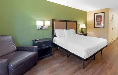 a bedroom with a bed and a couch and a chair at Extended Stay America Suites - Los Angeles - Valencia in Stevenson Ranch