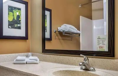 a bathroom with a sink with a mirror and towels at Extended Stay America Suites - Los Angeles - Valencia in Stevenson Ranch