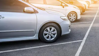 a row of parked cars in a parking lot at Kings Motel Inglewood in Inglewood