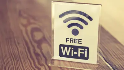 a sign for a free wifi sign on a table at Kings Motel Inglewood in Inglewood