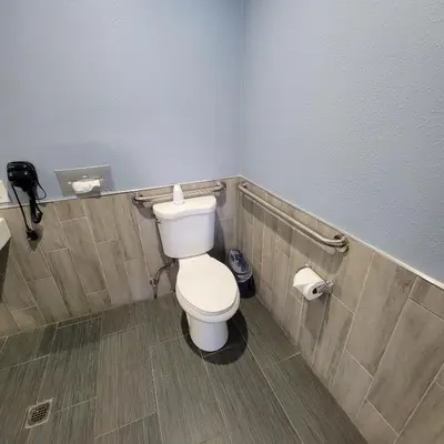 a bathroom with a white toilet in a room at Guest Harbor Inn- Port Of Los Angeles San Pedro in San Pedro