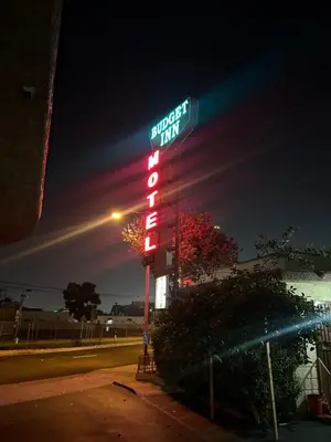 a neon sign for a fast food restaurant at night at Budget Inn Motel in South Gate