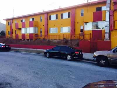 a black car parked on a street in front of a building at Relax Inn in Los Angeles