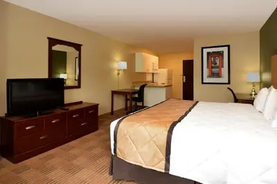 a hotel room with a bed and a flat screen tv at Extended Studio Hotel Suites - Los Angeles - San Dimas in San Dimas