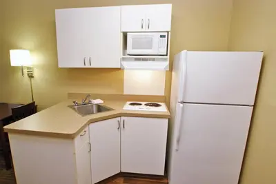 a kitchen with a white refrigerator and a sink at Extended Studio Hotel Suites - Los Angeles - San Dimas in San Dimas