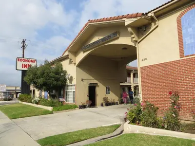 a building with a sign that reads covenant inn at Economy Inn LAX Inglewood in Inglewood