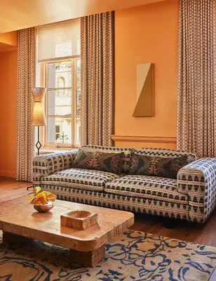 a living room with a couch and a coffee table at Downtown Los Angeles Proper Hotel, a Member of Design Hotels in Los Angeles