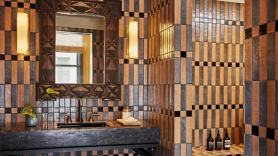 a bathroom with a sink and a mirror at Downtown Los Angeles Proper Hotel, a Member of Design Hotels in Los Angeles