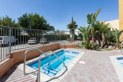 a small swimming pool next to a fence at Ramada Plaza by Wyndham Garden Grove/Anaheim South in Anaheim