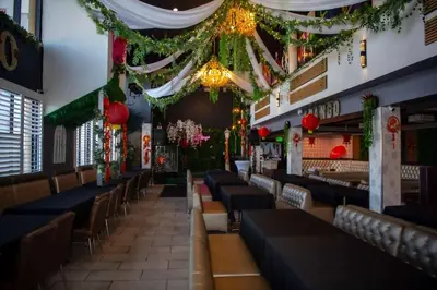 a dining room with rows of chairs and christmas decorations at Ramada Plaza by Wyndham Garden Grove/Anaheim South in Anaheim