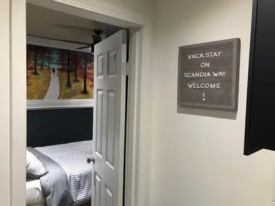 a door with a sign that reads west stay on sandy way welcome at VacaStay on Scandia Way in Los Angeles