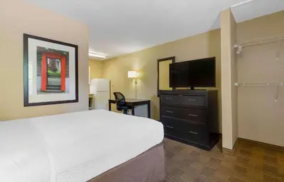 a hotel room with a bed and a flat screen tv at Extended Stay America Suites - Bakersfield - California Avenue in Bakersfield