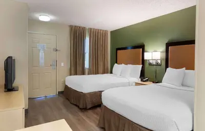 a hotel room with two beds and a television at Extended Stay America Suites - Bakersfield - California Avenue in Bakersfield