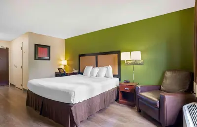 a hotel room with a large bed and a chair at Extended Stay America Suites - Los Angeles - Torrance Harborgate Way in Carson