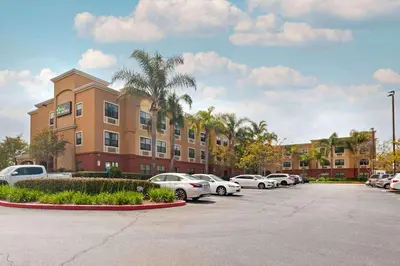a parking lot with cars parked in front of a building at Extended Stay America Suites - Los Angeles - Torrance Harborgate Way in Carson
