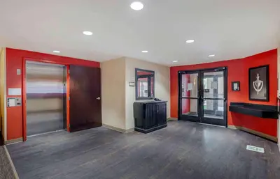 a living room with red walls and a tv in it at Extended Stay America Suites - Los Angeles - Torrance Blvd in Torrance