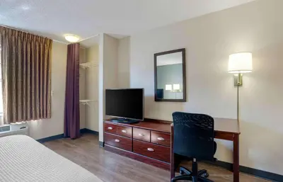 a hotel room with a bed and a desk with a television at Extended Stay America Suites - Los Angeles - Torrance Blvd in Torrance