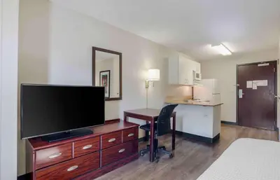a hotel room with a desk and a flat screen tv at Extended Stay America Suites - Los Angeles - Torrance Blvd in Torrance