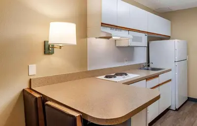 a kitchen with a counter and a white refrigerator at Extended Stay America Suites - Los Angeles - Monrovia in Monrovia