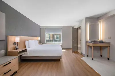a large bedroom with a bed and a window at Hyatt Place Riverside Downtown in Riverside
