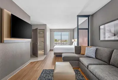 a living room with a couch and a bed at Hyatt Place Riverside Downtown in Riverside