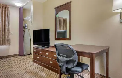 a room with a desk with a chair and a television at Extended Stay America Suites - Los Angeles - Ontario Airport in Guasti