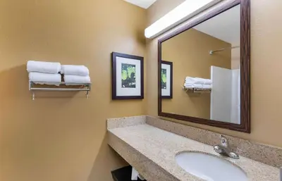 a bathroom with a sink and a mirror and towels at Extended Stay America Suites - Los Angeles - Ontario Airport in Guasti