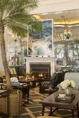 a lobby with a palm tree and a fireplace at Casa Del Mar in Los Angeles
