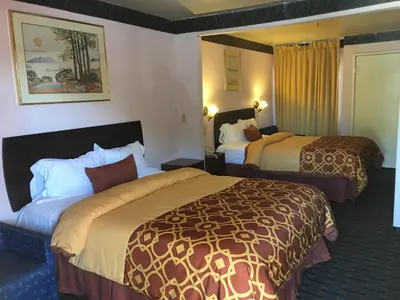 a hotel room with two beds in a room at Executive Suites Inn in Westminster