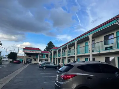 a car parked in a parking lot in front of a motel at Chester Inn Motel in Stanton