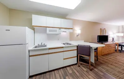 a kitchen with white cabinets and a white refrigerator at Extended Stay America Suites - Orange County - Cypress in Cypress