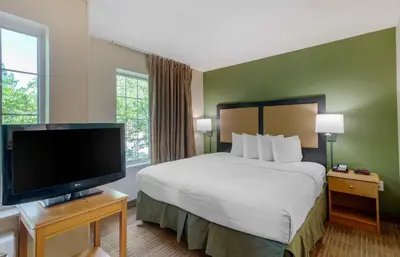 a hotel room with a bed and a flat screen tv at Extended Stay America Suites - Orange County - Cypress in Cypress