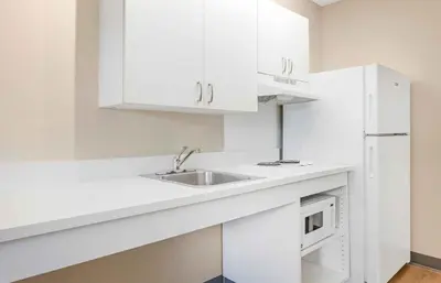 a white kitchen with a sink and a microwave at Extended Stay America Suites - Los Angeles - Torrance - Del Amo Circle in Torrance