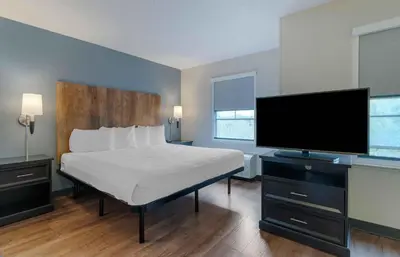 a bedroom with a bed and a flat screen tv at Extended Stay America Suites - Los Angeles - Burbank Airport in Burbank