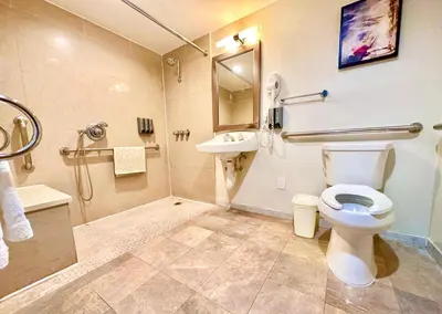 a bathroom with a toilet and a sink and a shower at Lincoln Hotel Monterey Park Los Angeles in Monterey Park