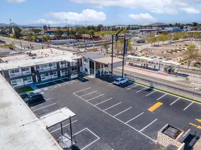 an empty parking lot in front of a building at Inland Inn & Suites in San Bernardino