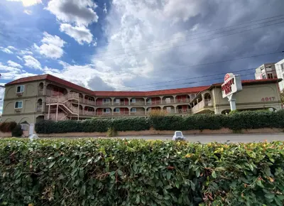 a large building with a sign in front of it at Colony Inn in North Hollywood