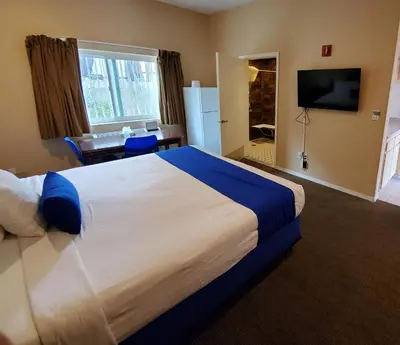 a hotel room with a large bed and a desk at Colony Inn in North Hollywood