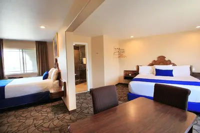 a hotel room with two beds and a table at Colony Inn in North Hollywood